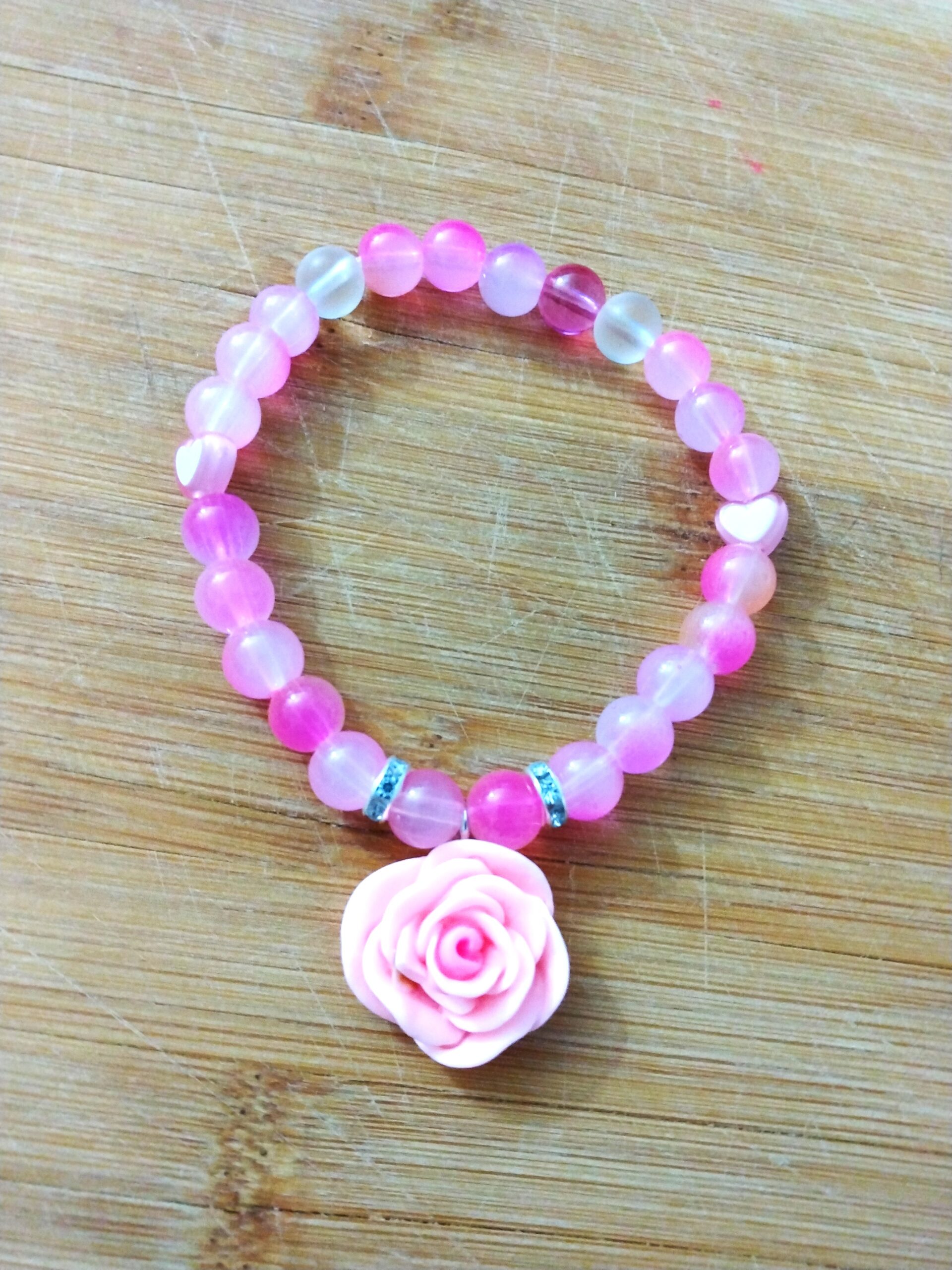 Pink shades of glass beads with a pink rose