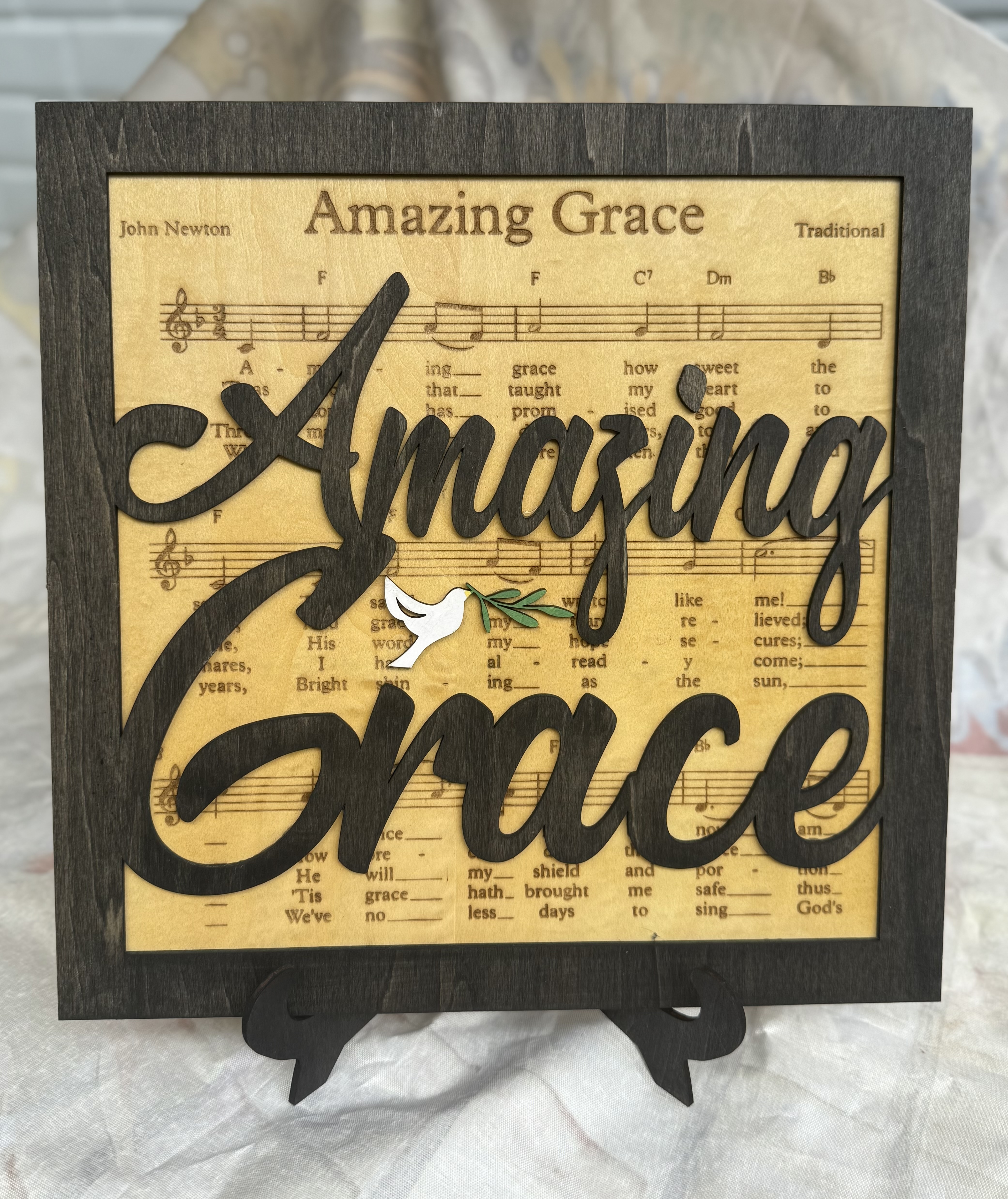 Amazing Grace on stand. With lyrics on wood.